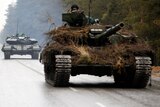 A Ukrainian tanks move on a road.