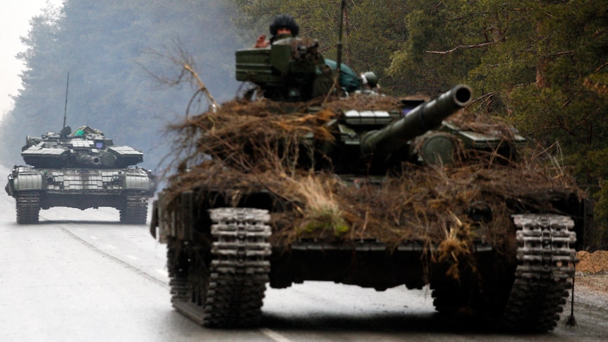 A Ukrainian tanks move on a road.