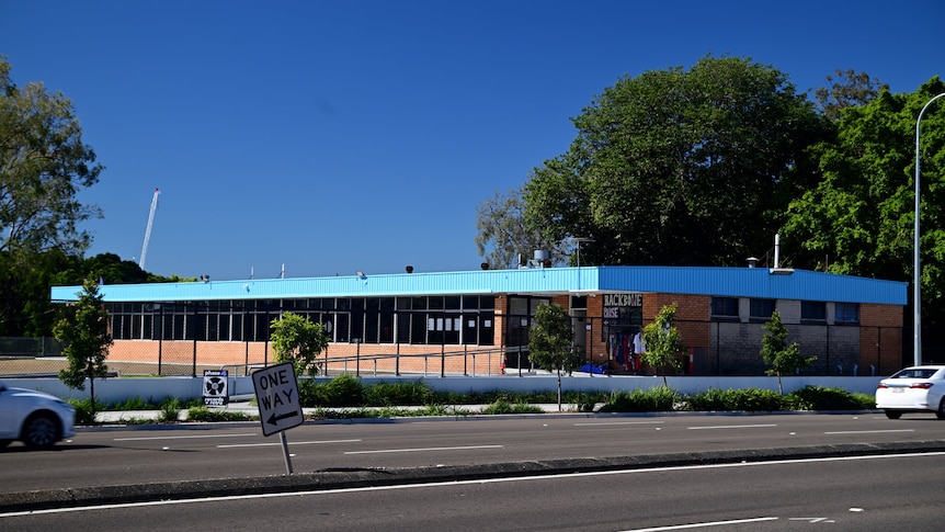 A low-set bowls club building next to a road