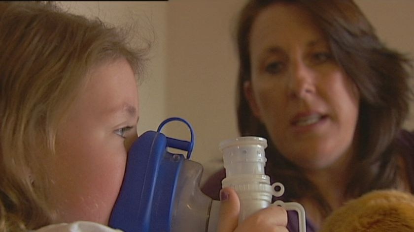 A child using a nebuliser for cystic fibrosis treatment