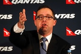 Qantas chief executive Alan Joyce announces the company's half-year results
