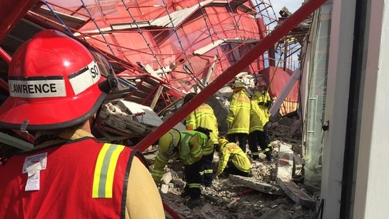 Fie crews search the rubble under a collapsed scaffold