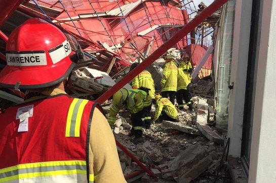 Fie crews search the rubble under a collapsed scaffold