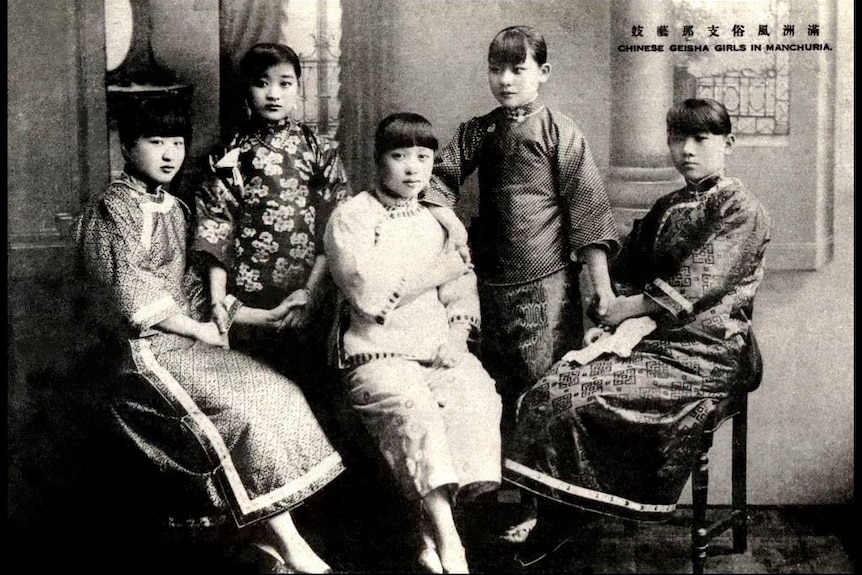 A black and white historical photo of five Chinese women, who may have been prostitutes.