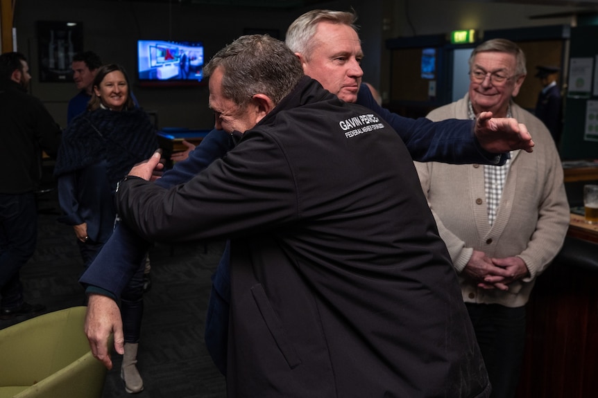 Liberal MP Gavin Pearce hugs Tasmanian Premier Jeremy Rockliff.