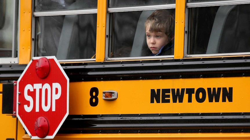 A child gazes from a school bus in Newtown, Connecticut.