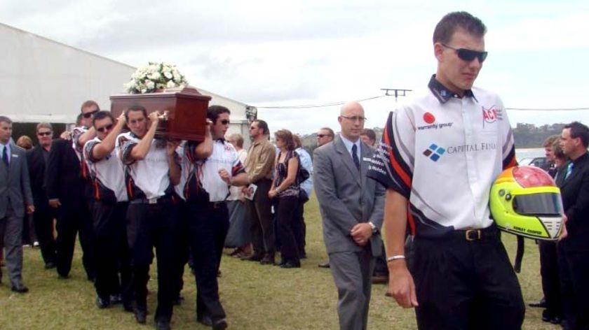 Friends carry the helmet and coffin of V8 Supercar driver Ashley Cooper