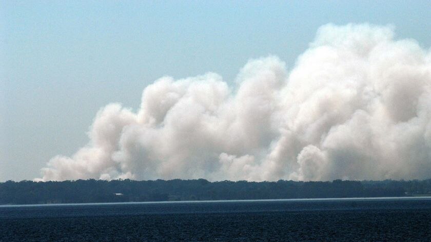 Smoke rises above Grahamstown Lake in Port Stephens