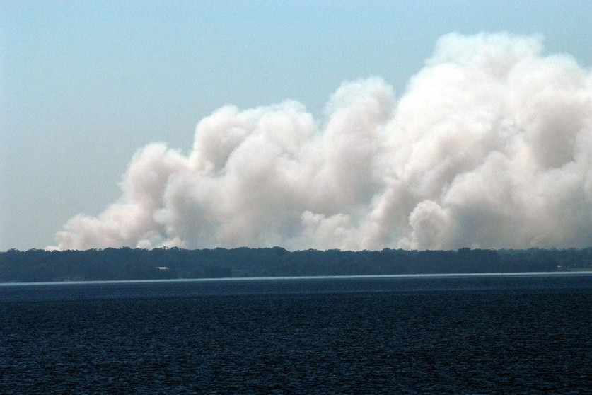 Smoke rises above Grahamstown Lake in Port Stephens