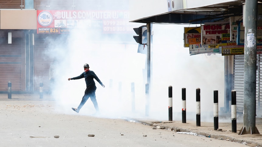 person walking surrounded by tear gas