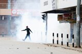 person walking surrounded by tear gas