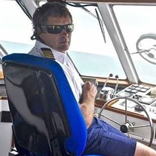 Steven Foster at the tiller of a water taxi in the driver's cabin