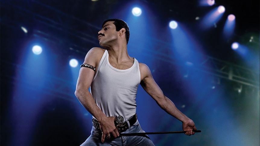 Colour still of Rami Malek as Freddie Mercury performing on stage in 2018 film Bohemian Rhapsody.