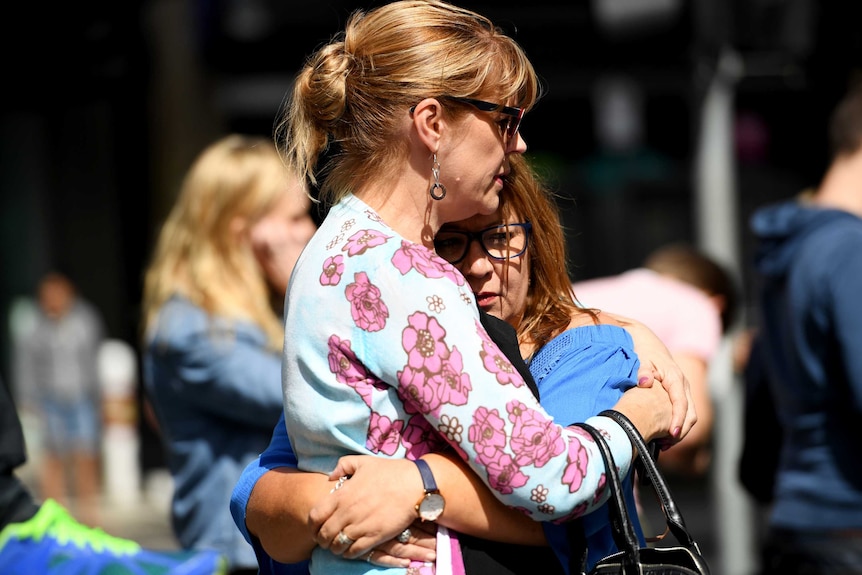 People hug in Melbourne