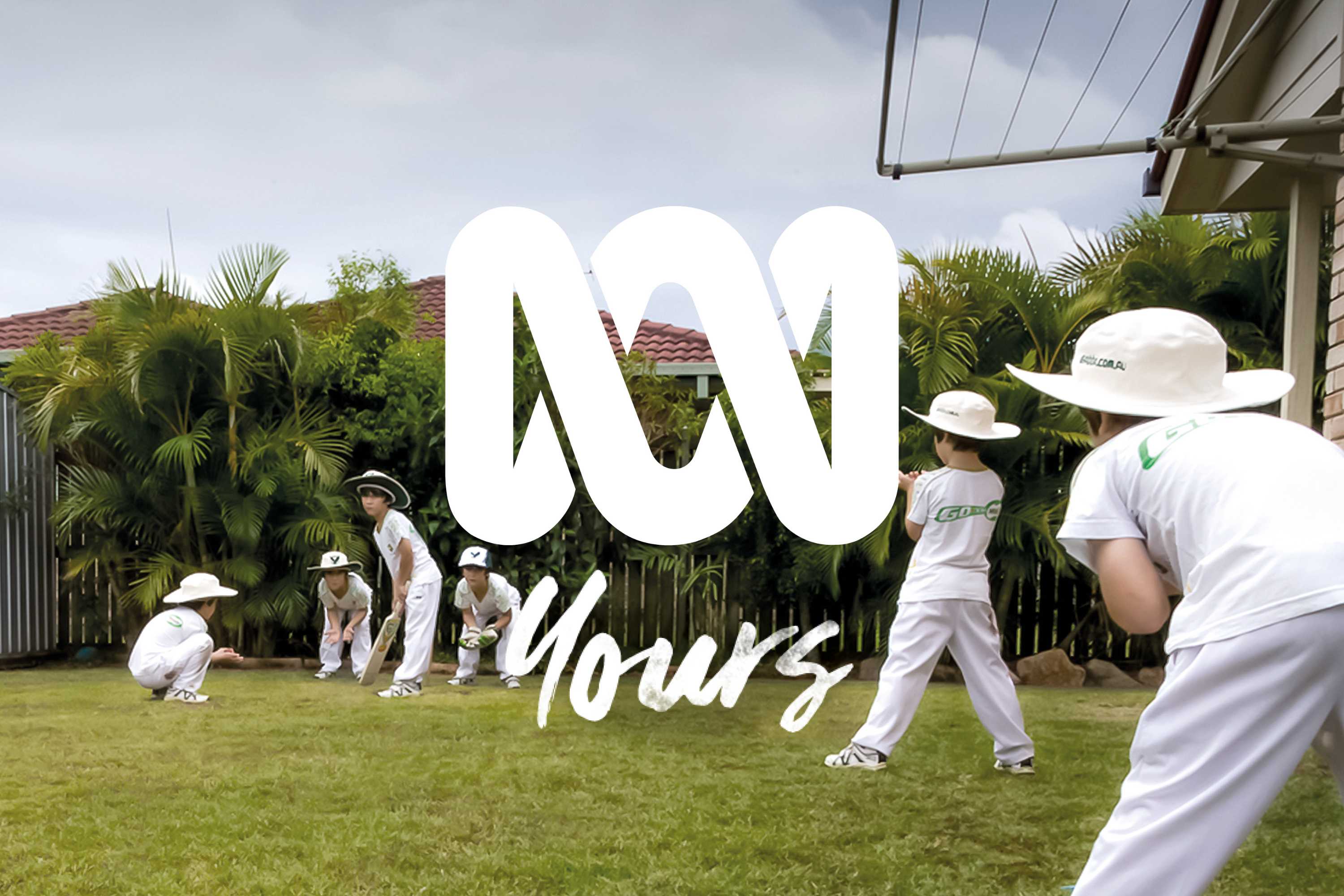 Six children playing backyard cricket
