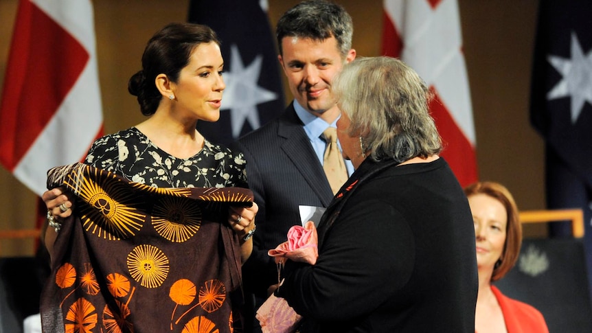 Princess Mary of Denmark and Prince Frederik of Denmark receive a present from an Aboriginal elder.