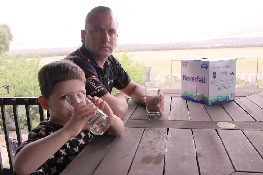 A man and child sit at a table.