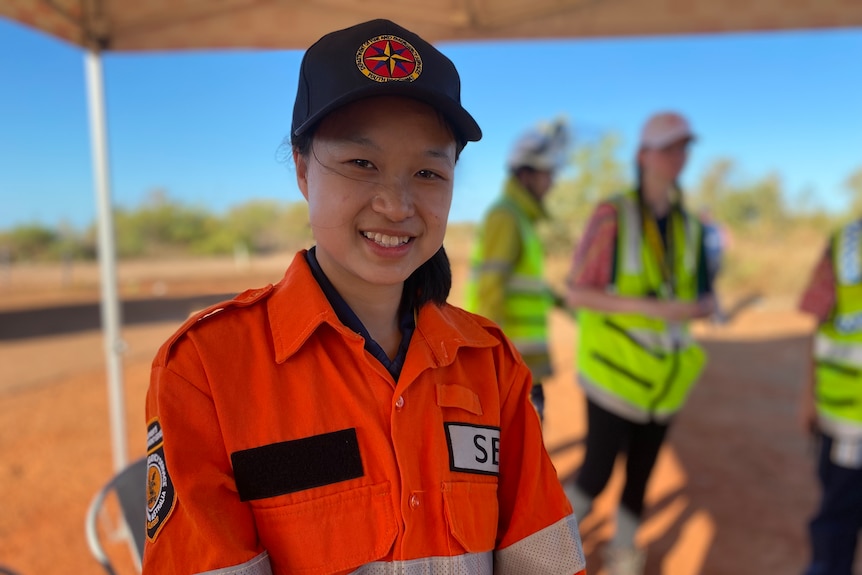 A smiling girl in an SES uniform