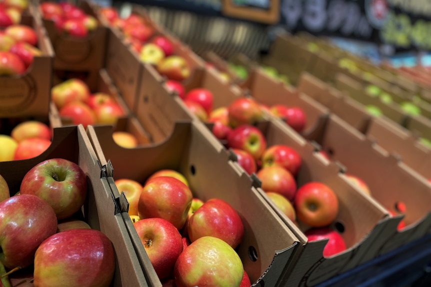 Apples in boxes at supermarket.