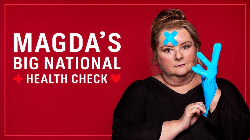Magda Szubanski against a red backdrop, stretching blue rubber gloves on one hand and has blue bandages marked X on her forehead