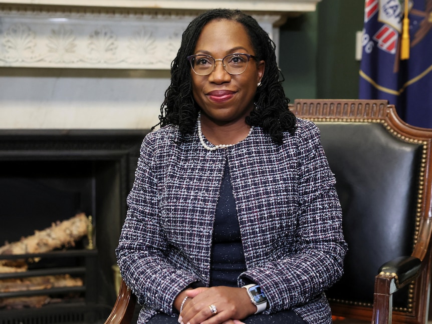 Judge Jackson sits in a green chair with her hands crossed