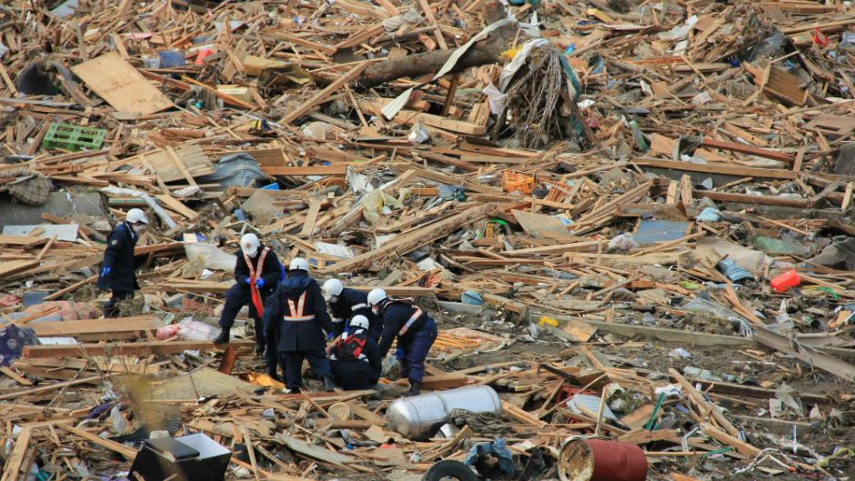 Emergency teams collect a body in Rikuzentakata