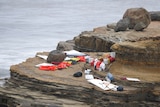 Items from a boat sit on the shoreline at Cabrillo National Monument near where it capsized just off the San Diego coast.