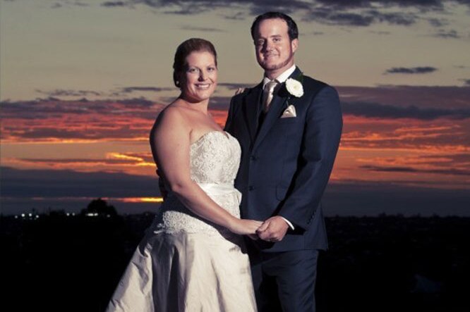 Sunset photo of Toowoomba couple Beth and Grant McEwan smiling and holding hands on their wedding day, date unknown.
