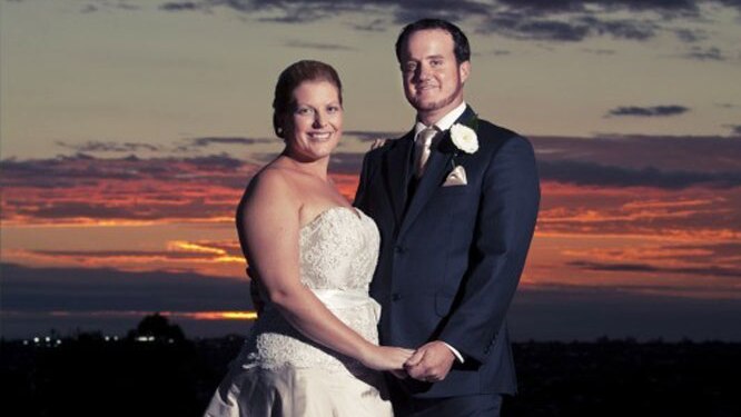 Sunset photo of Toowoomba couple Beth and Grant McEwan smiling and holding hands on their wedding day, date unknown.