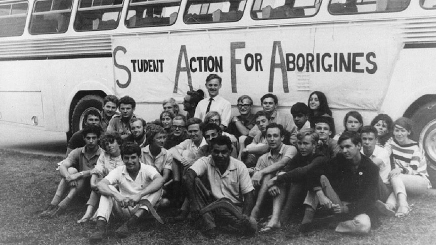 Freedom Riders sit in front of bus
