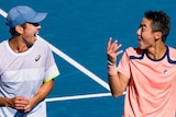 Doubles partners Rinky Hijikata and Jason Kubler share a laugh on-court at the Australian Open.