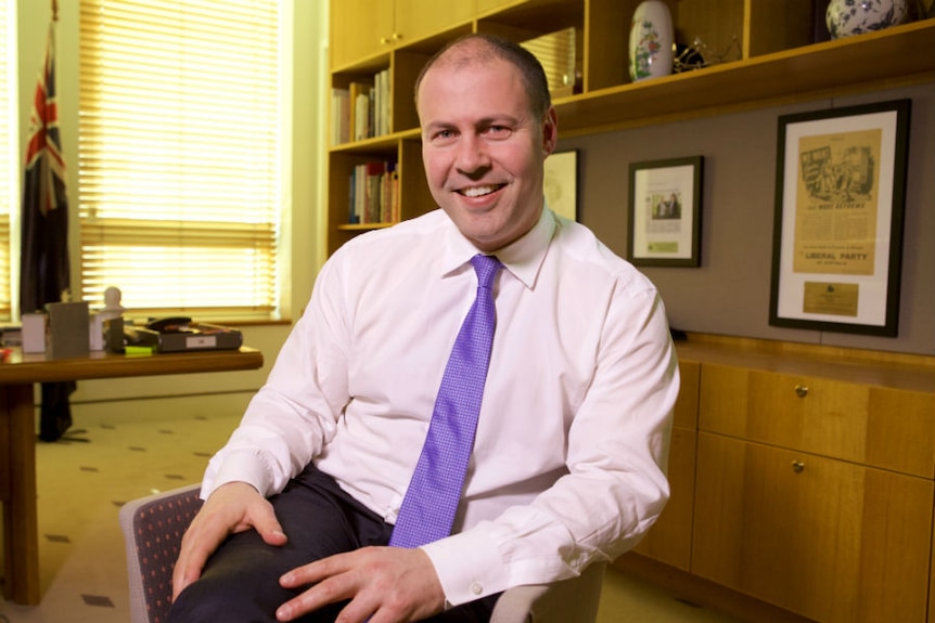 Josh Frydenberg sits cross-legged in his office at Parliament House