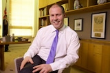 Josh Frydenberg sits cross-legged in his office at Parliament House