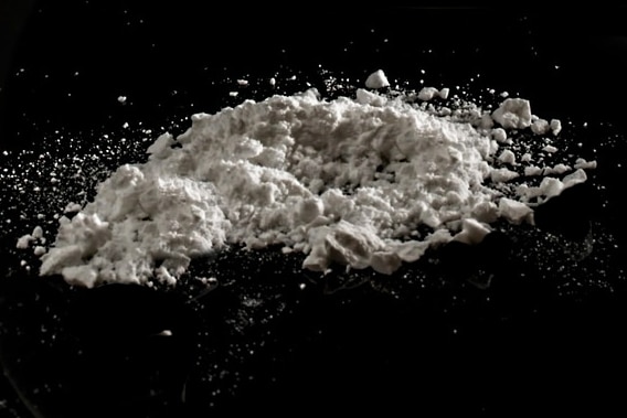 Pile of white powder on black surface.