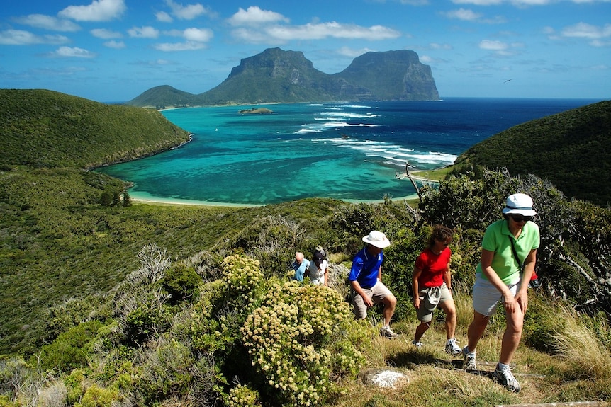 People hike up Mt Eliza on Lord Howe Island.