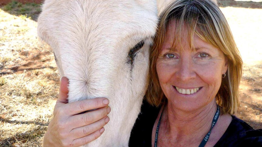 Gayle Woodford smiles with horse