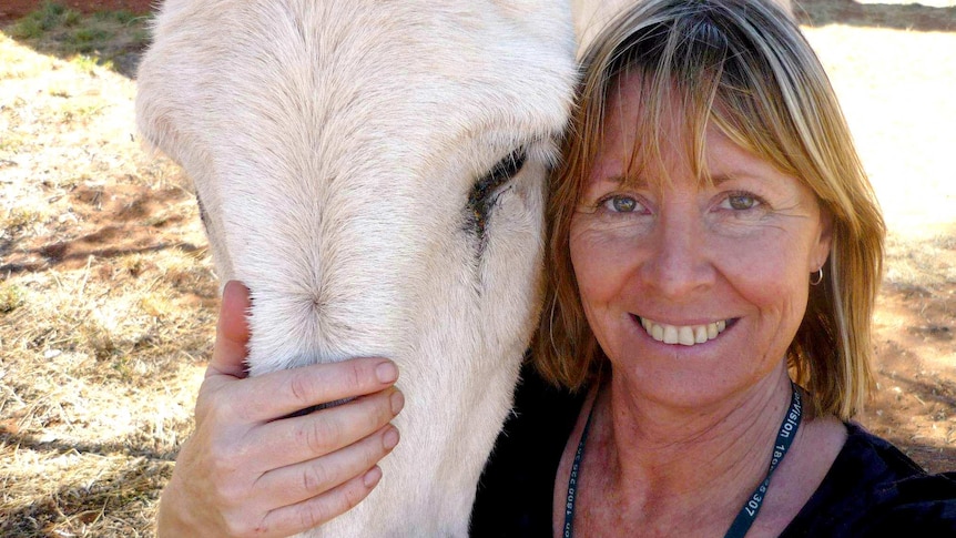 Gayle Woodford smiles with horse