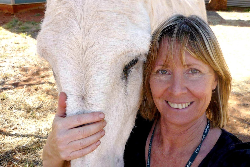 Gayle Woodford smiles with horse