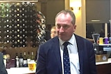 Deputy PM Barnaby Joyce standing at a bar