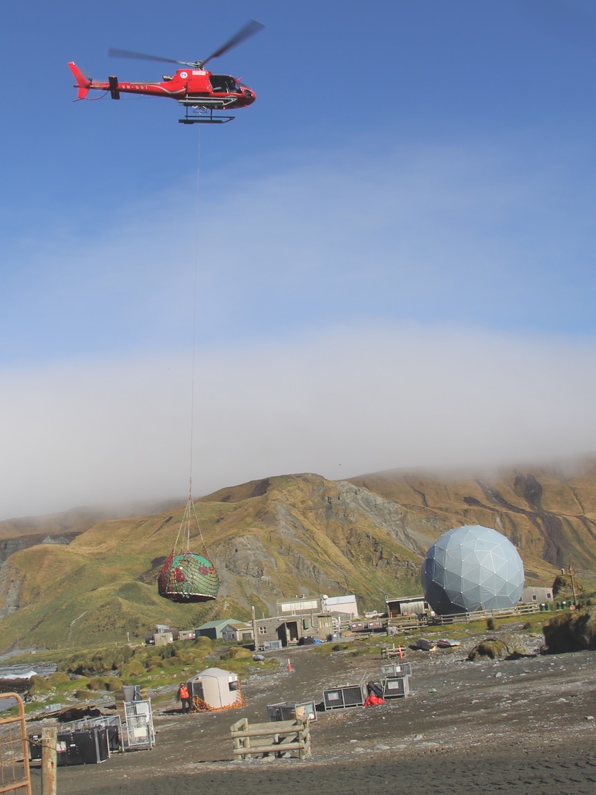 A hut on Macquarie Island is removed by helicopter