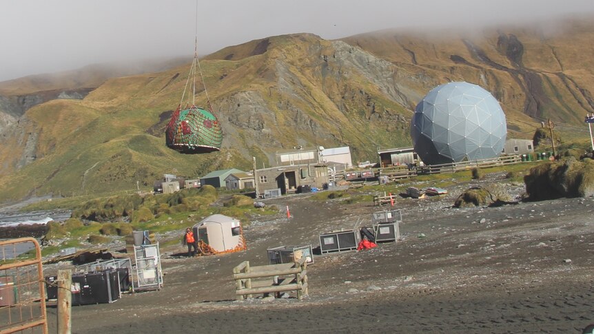 A hut on Macquarie Island is removed by helicopter