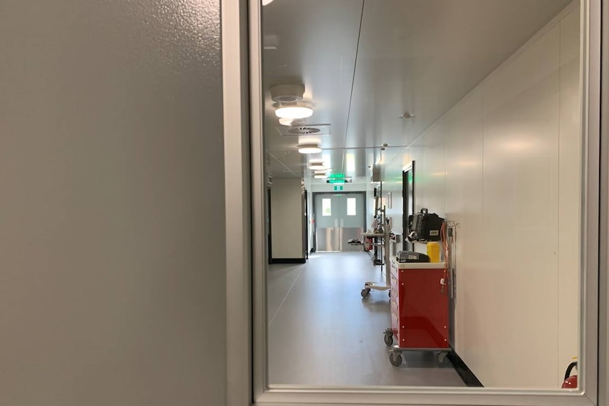 A view through a window into a room with special medical equipment.