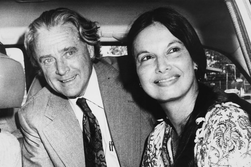 Black and white photo of middle aged man and young woman in car