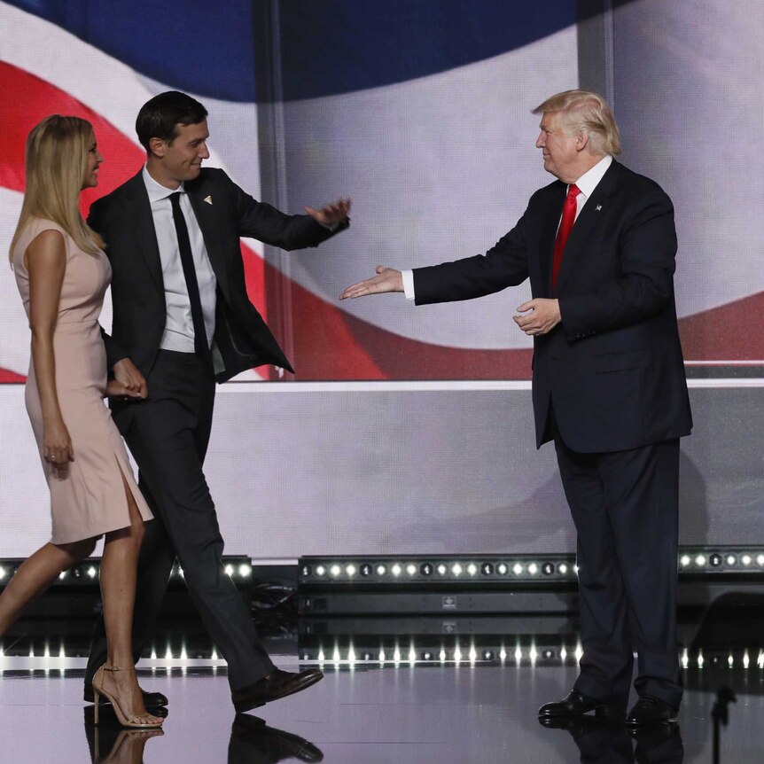 Donald Trump high-fives son-in-law Jared Kushner as Ivanka, Melania and Barron look on.