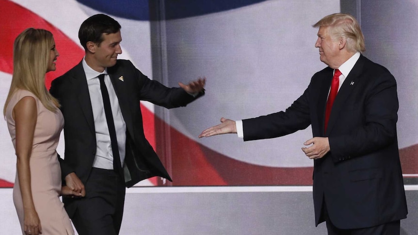 Donald Trump high-fives son-in-law Jared Kushner as Ivanka, Melania and Barron look on.