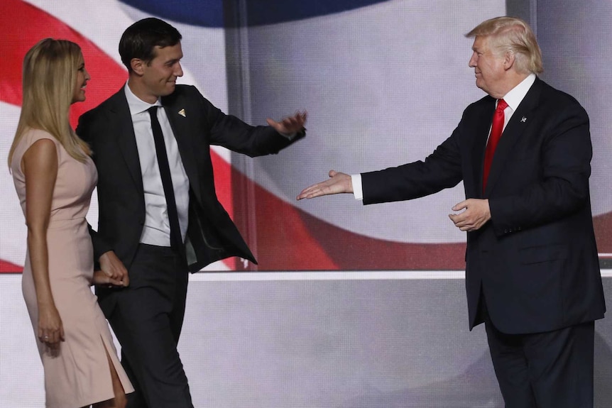 Donald Trump high-fives son-in-law Jared Kushner as Ivanka, Melania and Barron look on.