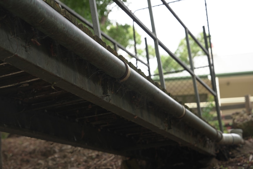 A bridge with a pipe attached, looking from under it
