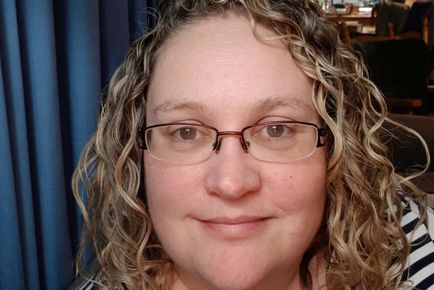 A selfie of National Breastfeeding Helpline volunteer Jennifer Hurrel in a lounge room.