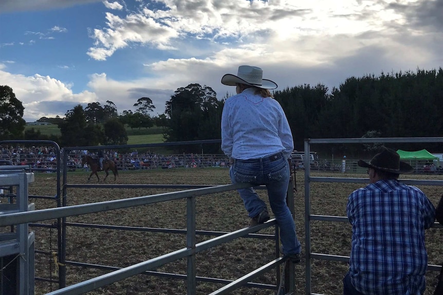 Female rodeo rider watching horse riding at the Wynyard Rodeo, February 2019