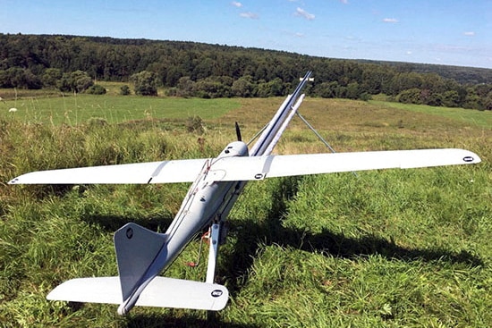 A plane shaped drone on a field